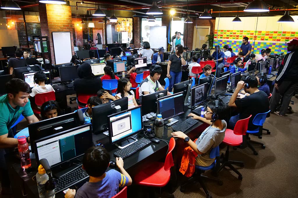 Busy Kidocode classroom of kids coding
