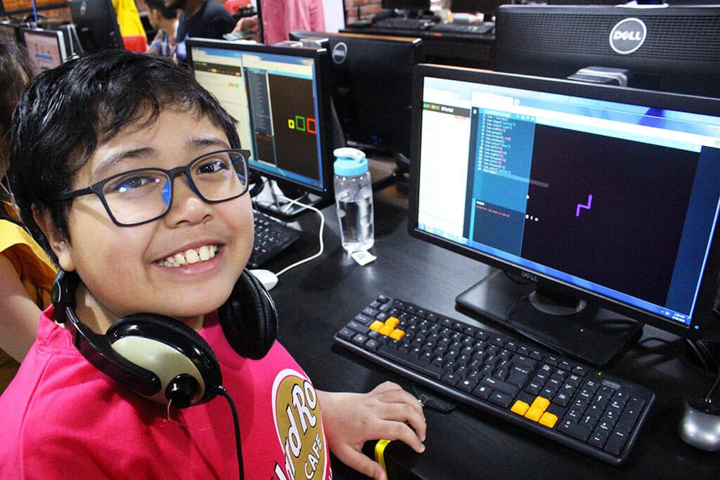 Kidocode student coding with dual monitors