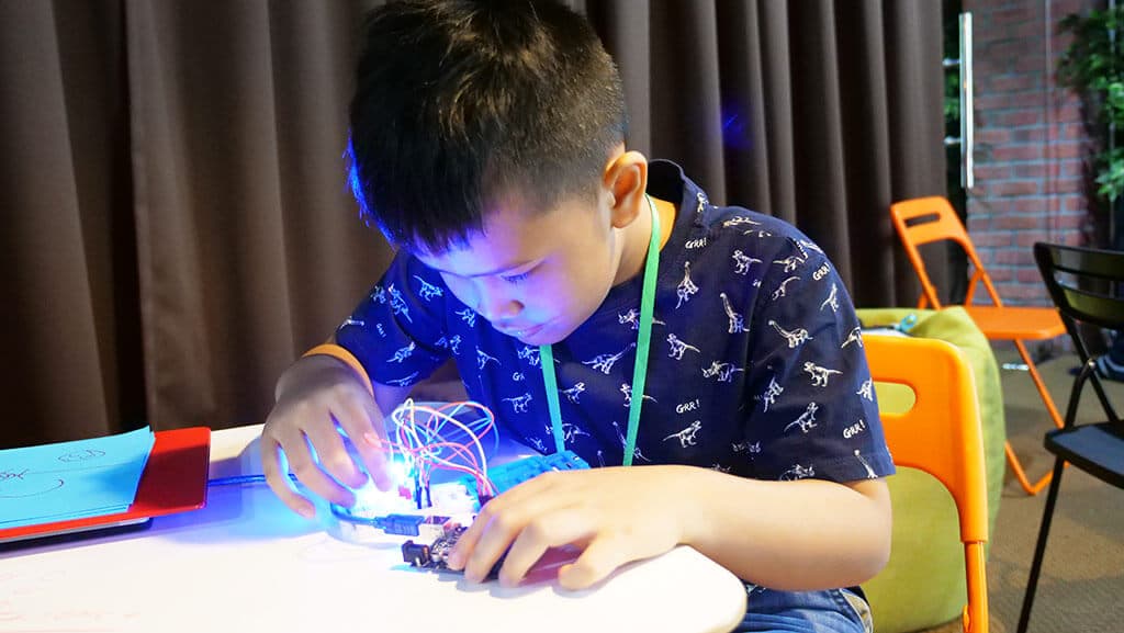 A Kidocode student lighting up an Arduino circuit they wired by hand