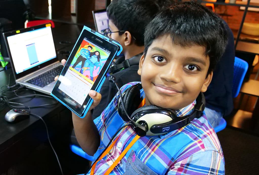 Kidocode student showing finished app on tablet
