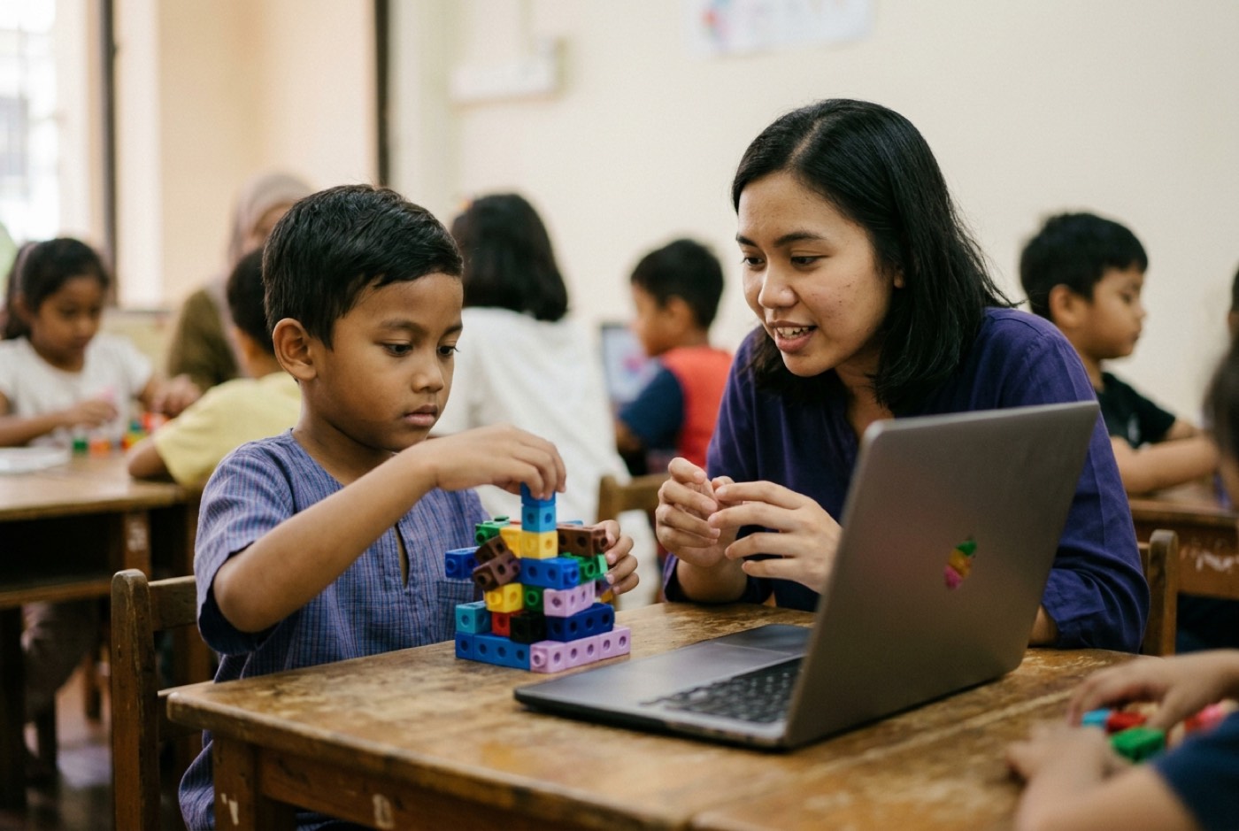 An instructor explaining neural network logic to a young student using physical building blocks and a laptop