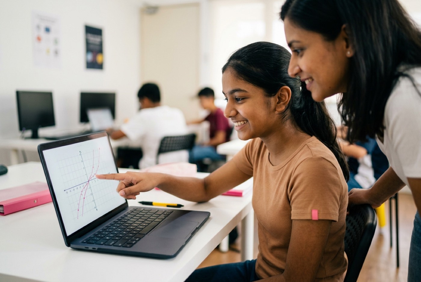 A teenage girl smiling while pointing at a clean mathematical graph on a laptop screen alongside an encouraging mento...